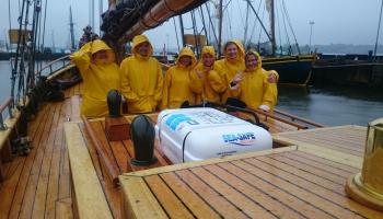 30 miles project picture. People sailing in the rain.