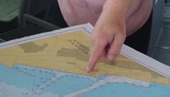 A person pointing a map.